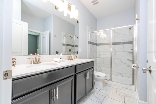 bathroom with walk in shower, vanity, and toilet