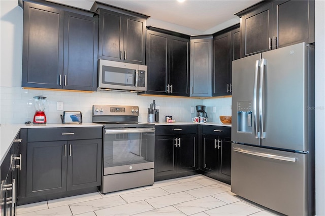 kitchen featuring stainless steel appliances and backsplash