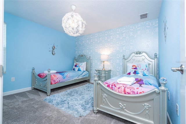 carpeted bedroom featuring an inviting chandelier