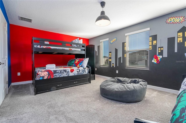 bedroom with carpet and a textured ceiling