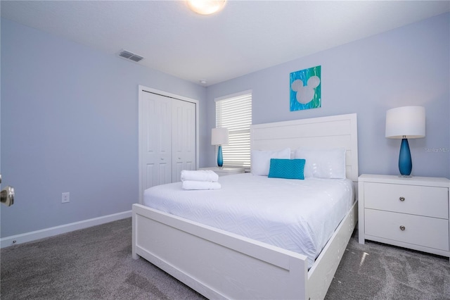 bedroom featuring dark colored carpet and a closet