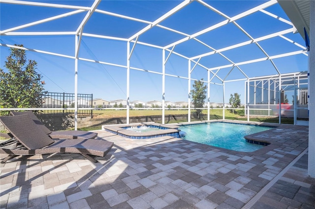 view of swimming pool featuring an in ground hot tub, a patio, and glass enclosure