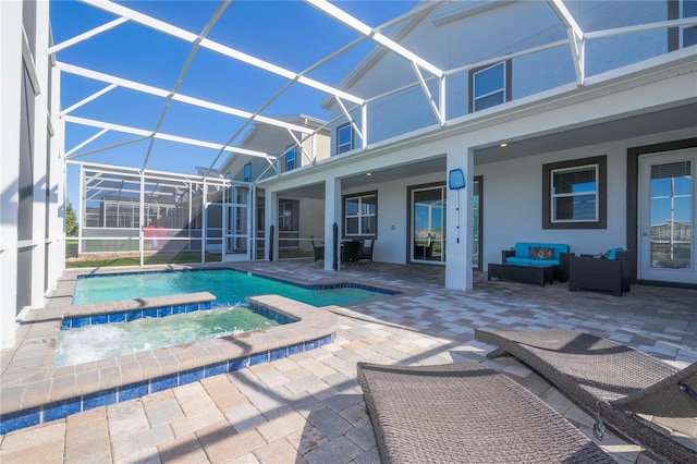 view of swimming pool with an in ground hot tub, outdoor lounge area, glass enclosure, and a patio area