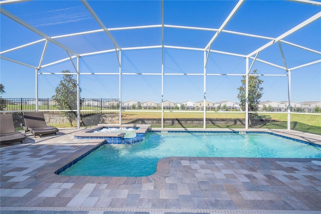 view of swimming pool with a patio area, an in ground hot tub, and glass enclosure