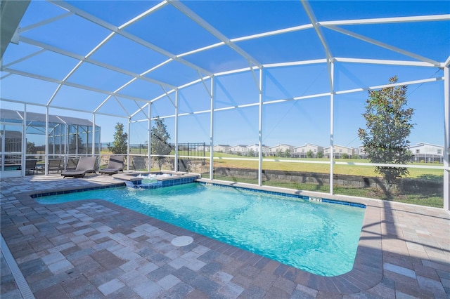 view of swimming pool with a lanai, a patio, and an in ground hot tub