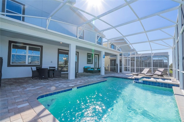 view of swimming pool with outdoor lounge area, a lanai, and a patio