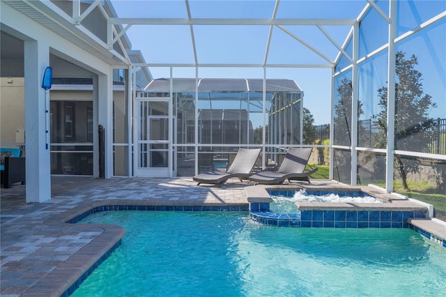 view of swimming pool with a patio, a lanai, pool water feature, and an in ground hot tub