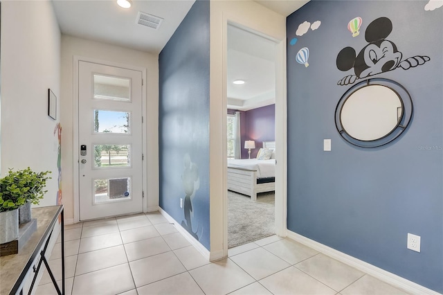 foyer with light tile patterned floors, visible vents, and a healthy amount of sunlight