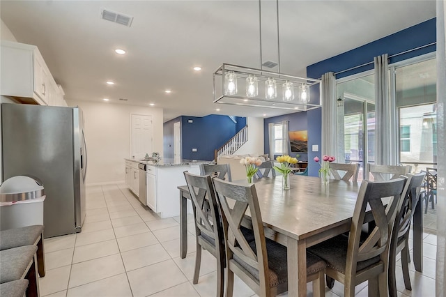 dining room with stairs, light tile patterned floors, recessed lighting, and visible vents