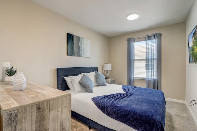 carpeted bedroom featuring baseboards