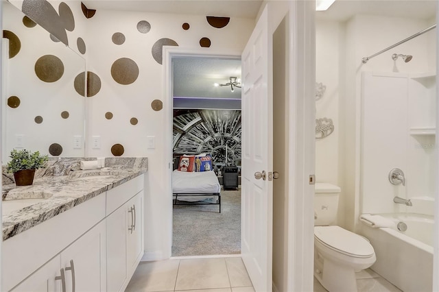 ensuite bathroom with vanity, bathtub / shower combination, tile patterned floors, toilet, and connected bathroom