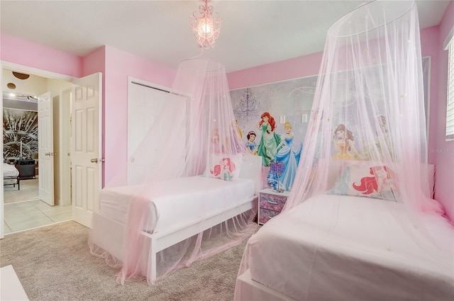 bedroom with tile patterned floors, a closet, and carpet