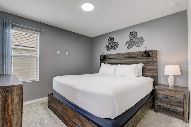 carpeted bedroom featuring baseboards