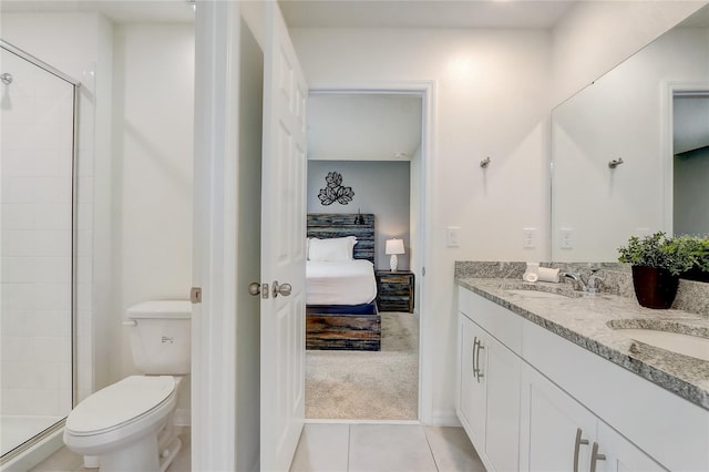 bathroom with tile patterned floors, vanity, toilet, and a shower with door