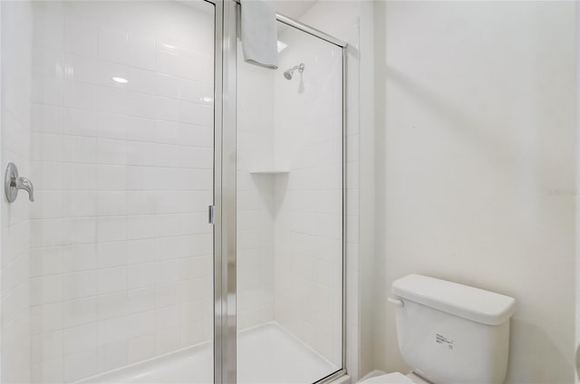 full bath with toilet and a stall shower