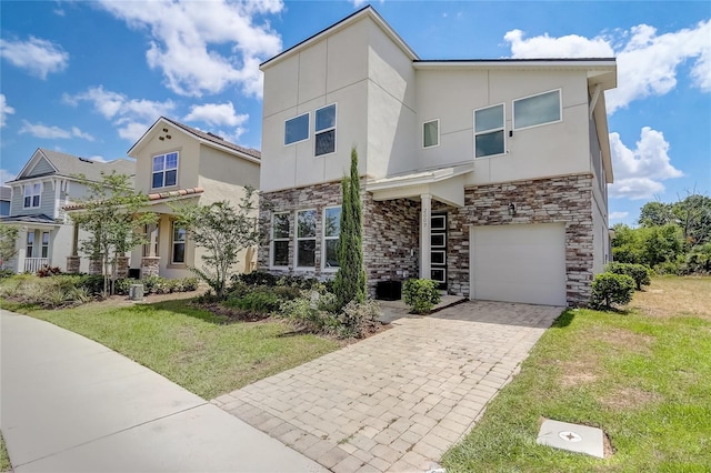 view of front of property with a front yard and a garage