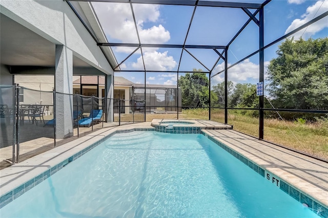 view of swimming pool featuring a patio, a lanai, and a pool with connected hot tub