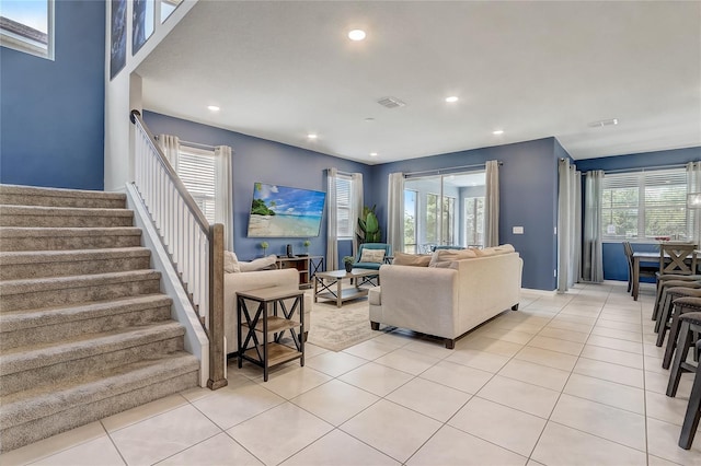 living room featuring recessed lighting, visible vents, stairs, and light tile patterned floors