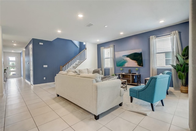 living area featuring stairway, light tile patterned floors, recessed lighting, and visible vents