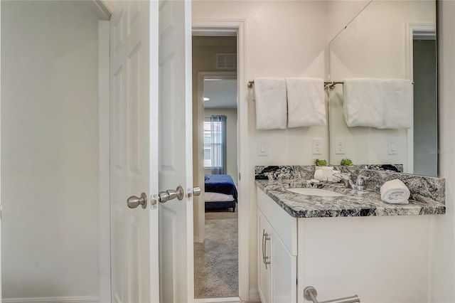 ensuite bathroom featuring visible vents, vanity, and ensuite bathroom