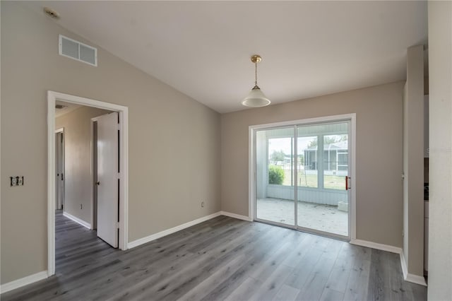 unfurnished dining area featuring dark hardwood / wood-style flooring and lofted ceiling