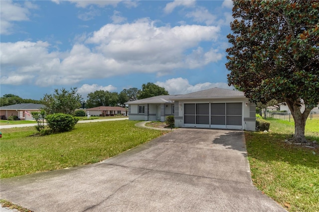 ranch-style home featuring a front lawn and a garage