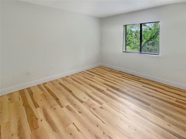 empty room with light hardwood / wood-style flooring