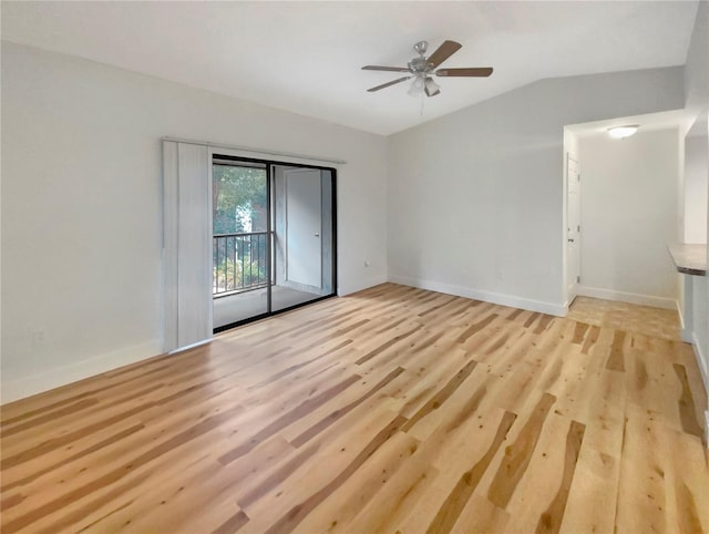 spare room featuring light wood-type flooring, ceiling fan, and lofted ceiling