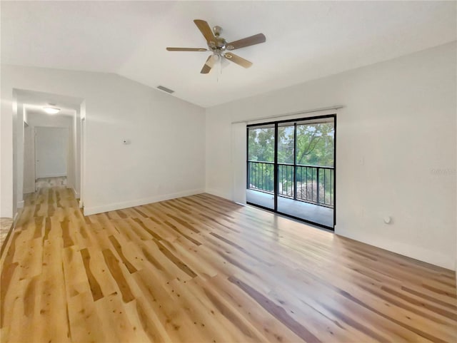 empty room with ceiling fan, light hardwood / wood-style floors, and vaulted ceiling