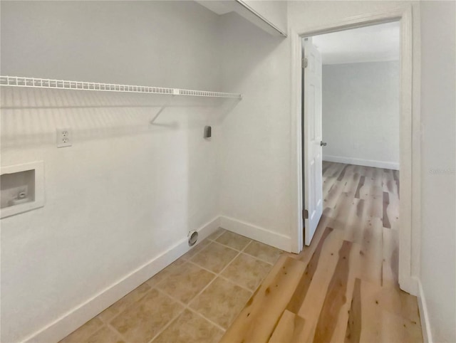 washroom featuring electric dryer hookup, hookup for a washing machine, and hardwood / wood-style flooring