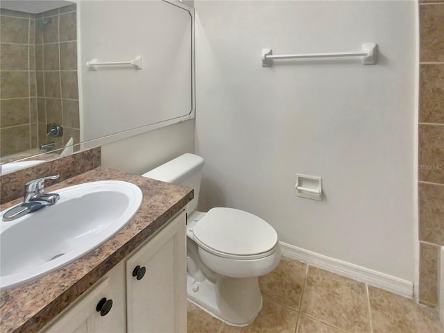 bathroom featuring tile patterned flooring, vanity, and toilet