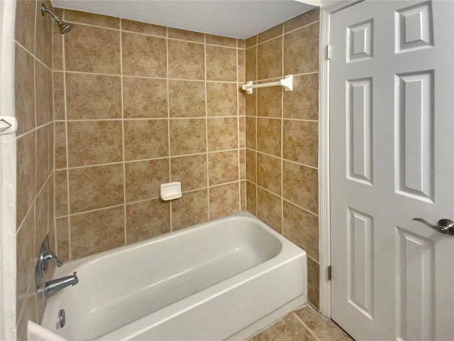 bathroom featuring tile patterned flooring and tiled shower / bath