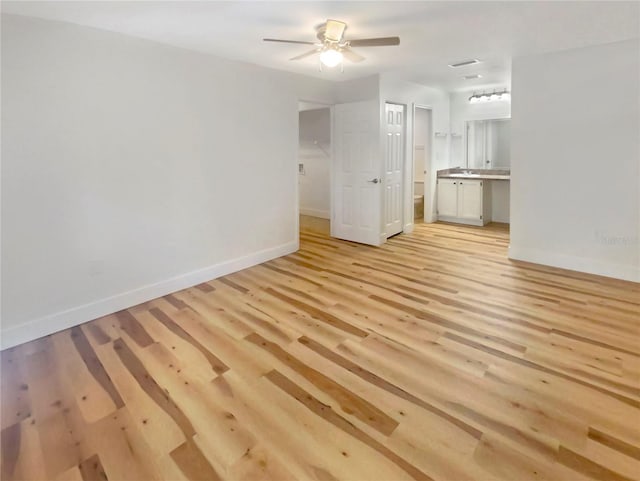 unfurnished room featuring ceiling fan and light wood-type flooring