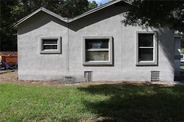 view of side of home featuring a yard