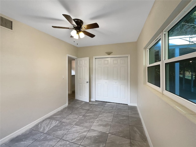 interior space with a closet and ceiling fan