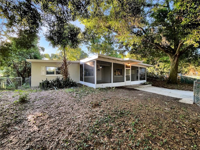 back of property with a sunroom