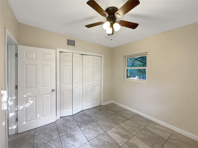 unfurnished bedroom with a closet and ceiling fan