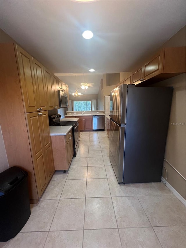 kitchen with light tile patterned floors, stainless steel appliances, and ceiling fan