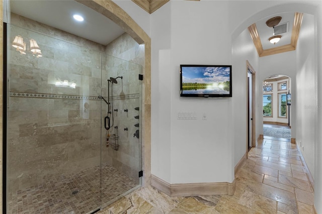 bathroom with crown molding and walk in shower