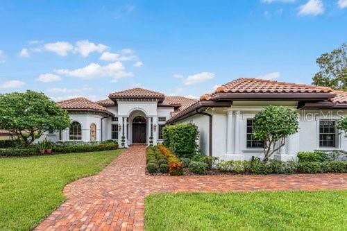 mediterranean / spanish-style home featuring a front lawn