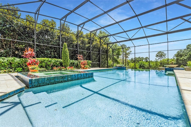 view of swimming pool with an in ground hot tub and a lanai