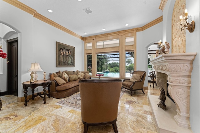 living room with a premium fireplace and crown molding