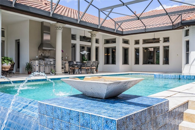 view of pool with pool water feature, a patio area, area for grilling, ceiling fan, and a grill