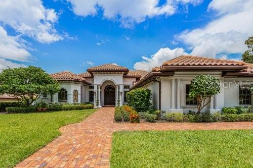 mediterranean / spanish home featuring a front lawn