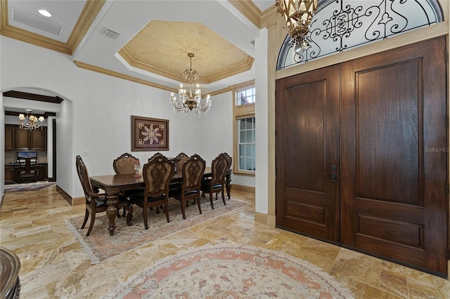 dining area featuring crown molding and an inviting chandelier