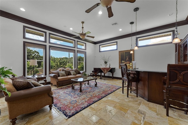 living room with ornamental molding, bar area, and ceiling fan