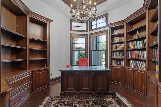 office featuring a raised ceiling, dark wood-type flooring, and an inviting chandelier