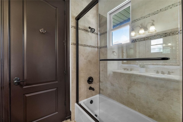 bathroom featuring bath / shower combo with glass door