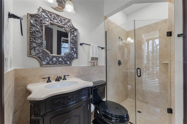 bathroom with vanity, tile walls, and walk in shower