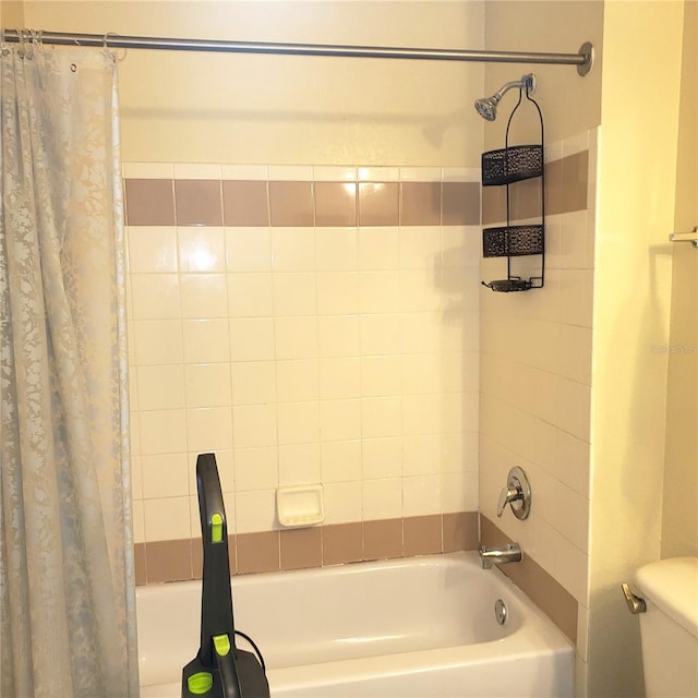 bathroom with shower / bath combination with curtain and toilet